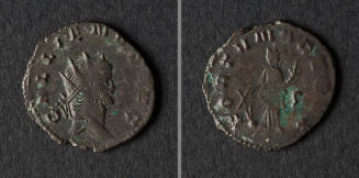 A dark grey bronze coin from the Roman Empire with spots of green discoloration and chips along…