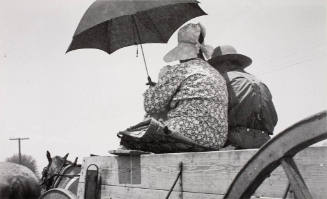 A farmer and his wife in a farm wagon in Arkansas, August 1936