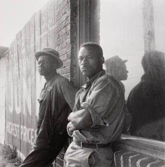 Laborers waiting hoping to get work chopping cotton on a cotton plantation .....