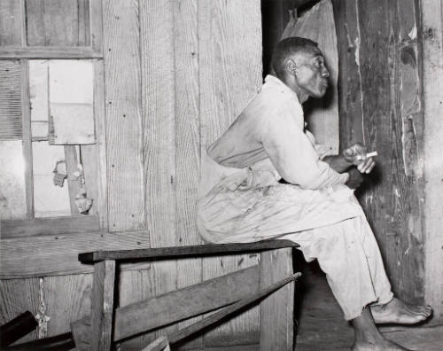 A Negro strawberry sharecropper on the front porch of his home. Vicinity of.....