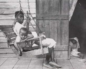 A Negro mother with her children on the porch of her home, Paulina, LA, ........