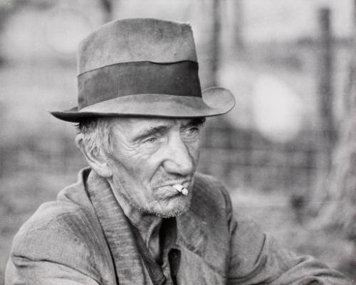 A migrant worker resting along the roadside in Mississippi, October 1938.