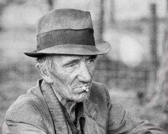 A migrant worker resting along the roadside in Mississippi, October 1938.