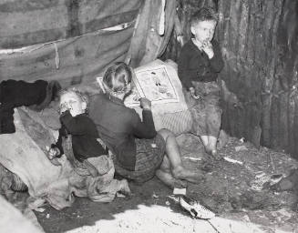 Children of Migrant Packing House Workers Who Are Living in a "Lean-to" Made of Pieces of Rusty Galvanized Tin and Burlap. They Are Left Alone All Day and Often Until 3 AM While Their Parents Are Working, Belle Glade, Florida, January 1939.