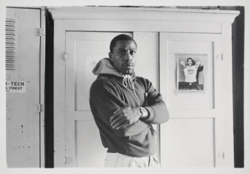 Reggie Walker Posed near a Picture of Ken Norton